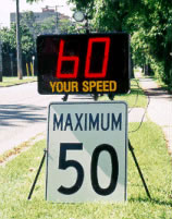 A digital sign telling drivers their current speed above a 50 kilometers per hour speed limit sign