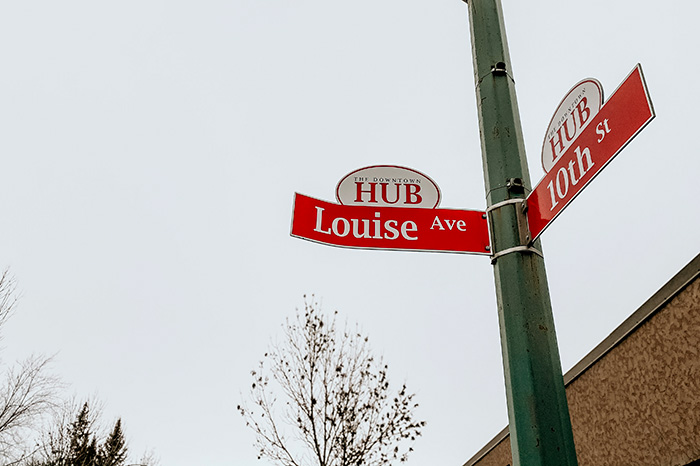 Street signs showing Louise Ave and 10th St